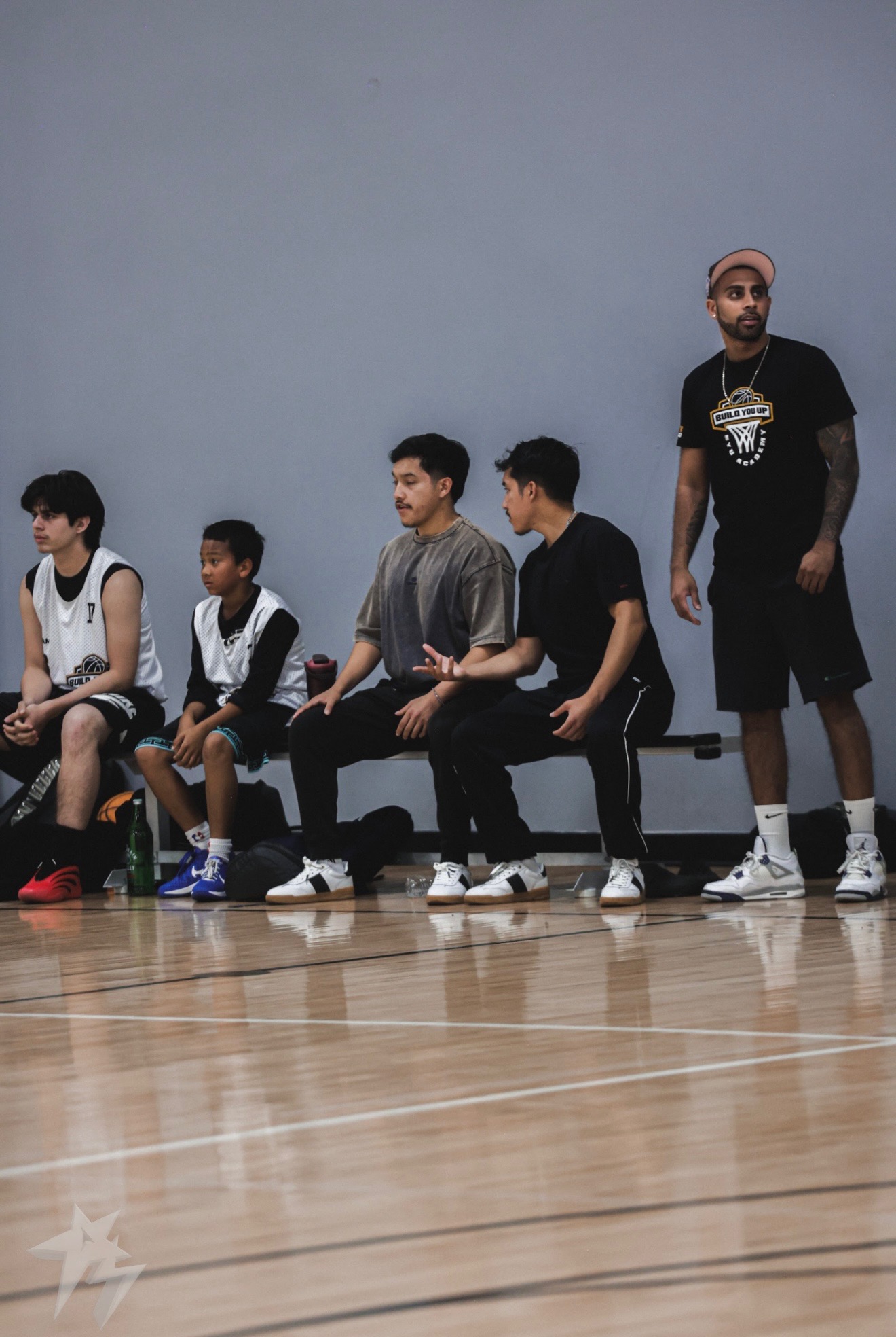 Coach Govin on the sideline with BYU Academy players during game reps