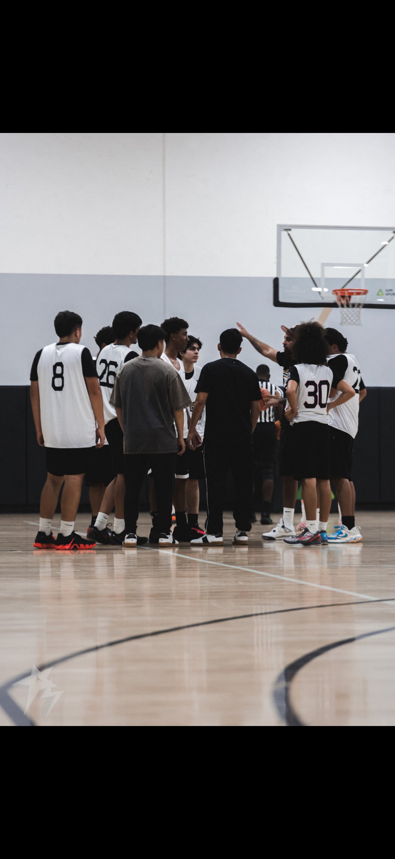 Coach Govin breaking down skills with TTG players in a huddle